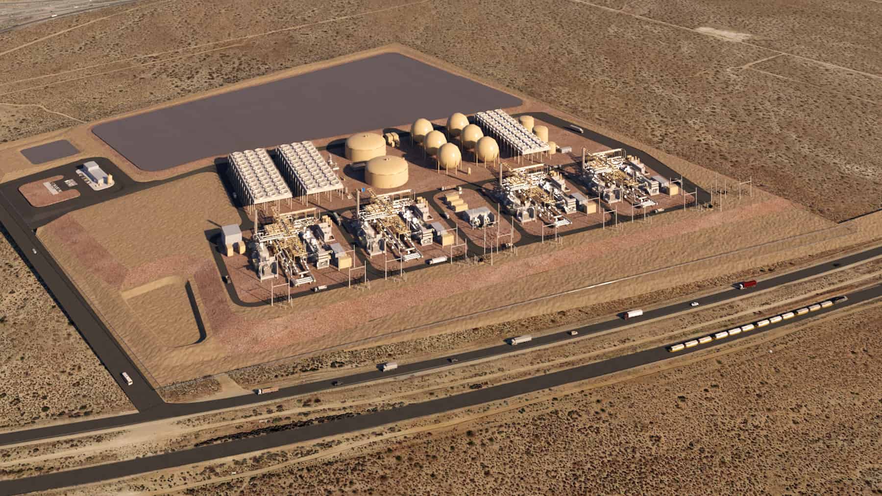 Aerial view of an industrial facility featuring storage tanks and machinery, possibly for underground energy storage or Advanced Compressed Air Energy Storage, with rectangular buildings set in a desert landscape bordered by roads and vehicles.