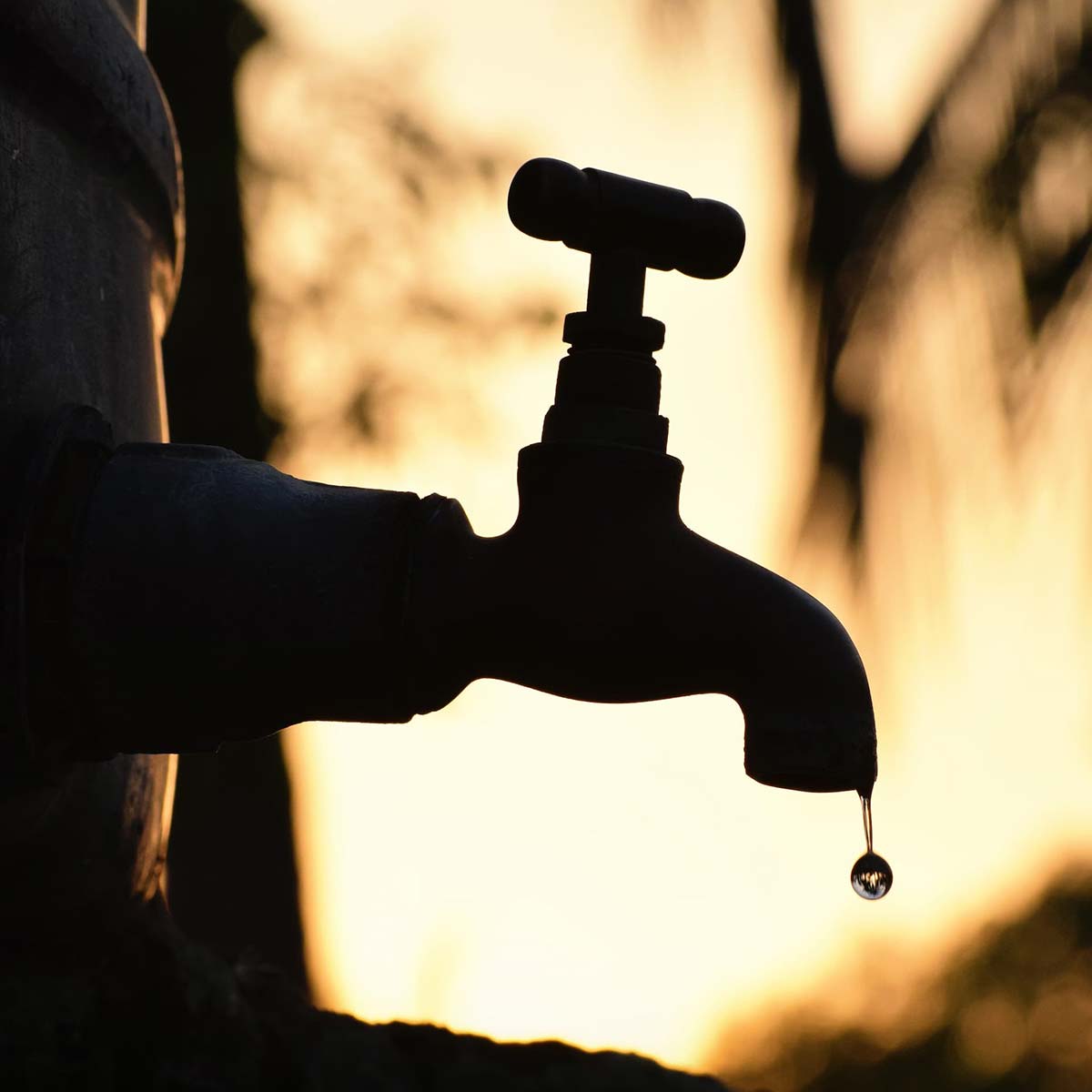 Groundwater Monitoring Silhouette of a dripping faucet